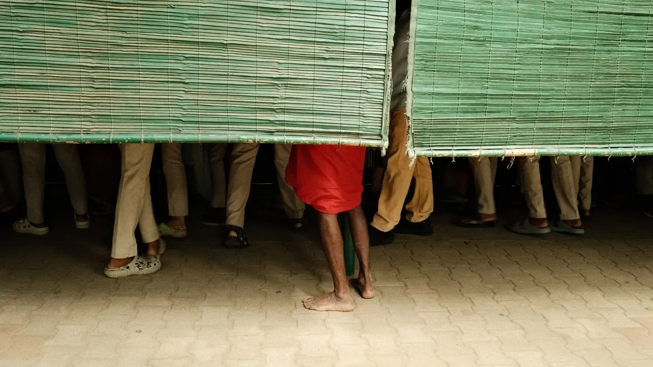 Man standing in a crowd watching snakes